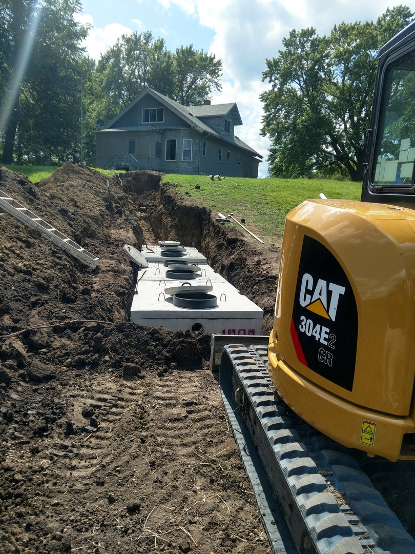 CAT excavator installing septic system